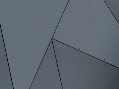 Abstract geometric facade with grey panels and sharp lines in London, Ontario.