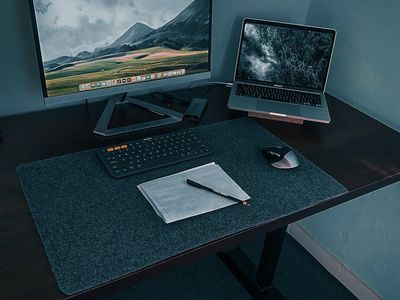 Minimalist desk setup with laptop and amber lighting